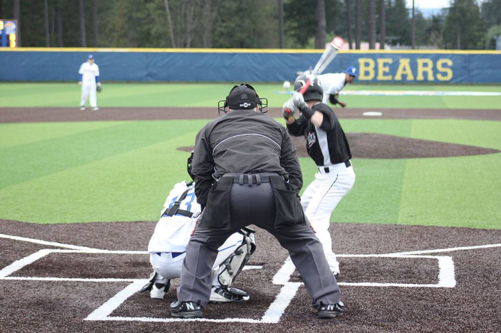 Tahoma junior Josh Leonard throws a pitch to Kentlake senior Kyle Combs Wednesday at the new Tahoma High School. The Falcons won 7-3. SARAH BRENDEN, The Reporter