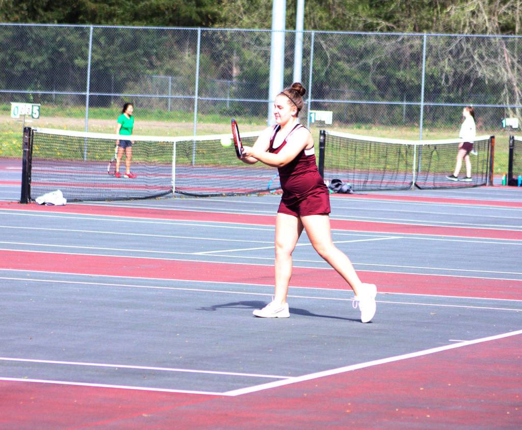 Kentlake Katie Valerio focuses on her return during her match against Chiamaka Okafor from Kentwood.