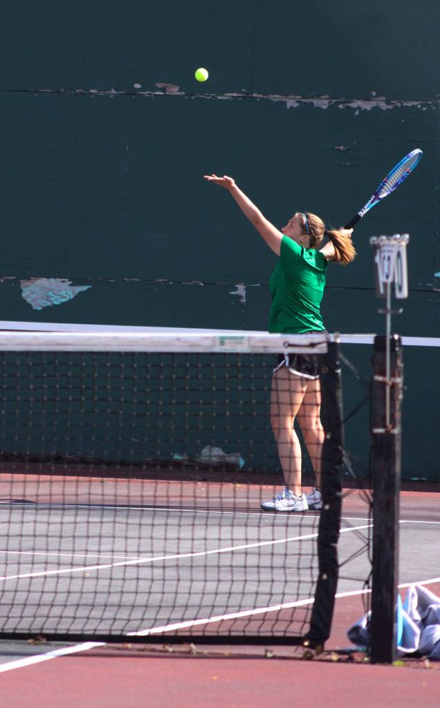 Sam Tate from Kentwood serves the ball during her match Wednesday with doubles partner Danielle Mendoza against Hallie Fredericks and Amber Smith.