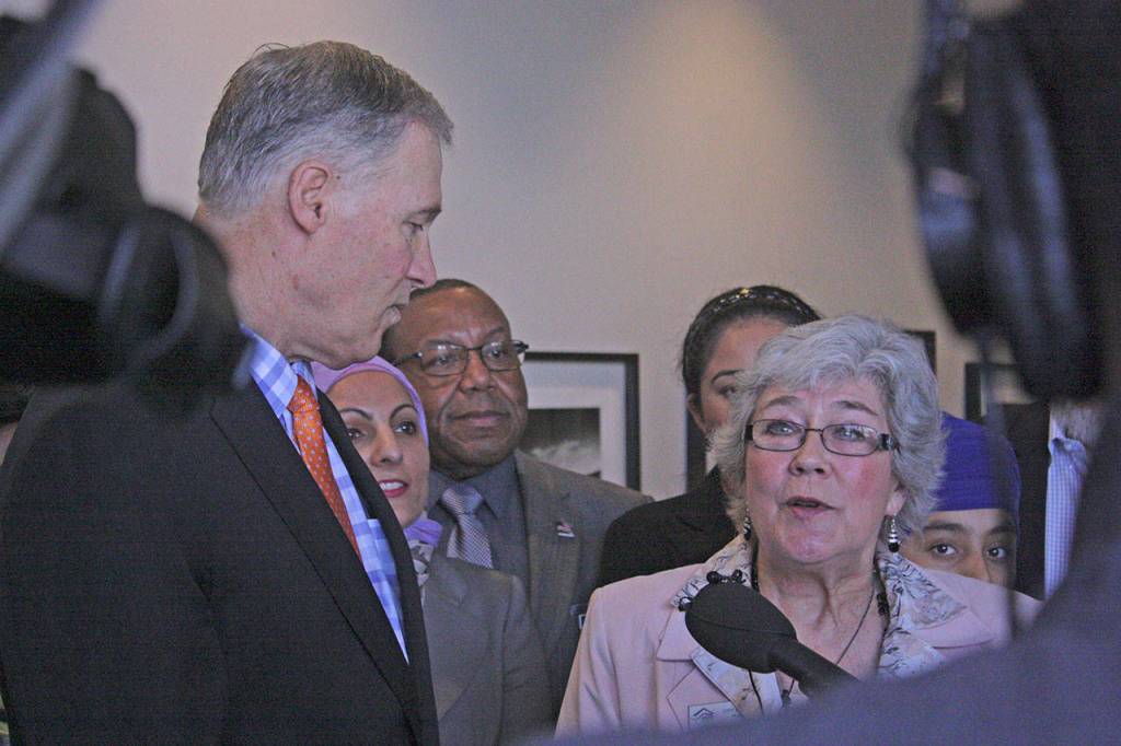 Flanked by Gov. Jay Inslee, Kent Mayor Suzette Cooke talks about the importance of including immigrants in the community during a news conference at Kent&rsquo;s Centennial Center on Thursday. Inslee visited Kent for a roundtable discussion on hate crimes. MARK KLAAS, Kent Reporter