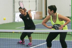 Takako Tourangeau returns a shot Saturday at the Pickleball Station grand opening in Kent.