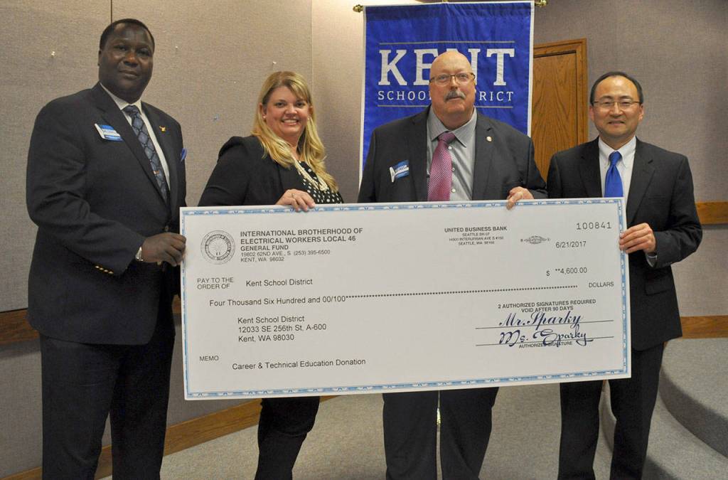 IBEW Local 46 recently presented the Kent School District with a $4,600 donation for its Career and Technical Education program. From left are Sean Bagsby, president of IBEW Local 46; Lorianne Paxton, Kent School District&rsquo;s director of Career and Technical Education; Jim Tosh, IBEW Local 46&rsquo;s business manager and financial secretary; and Eric Hong, school improvement officer for the Kent School District. HEIDI SANDERS, Kent Reporter