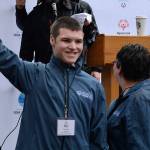Justin Olds holds up the swimming sign proudly during the 2018 Special Olympics Home Team Announcement in Seattle on Jan. 11. Photo by Kayse Angel