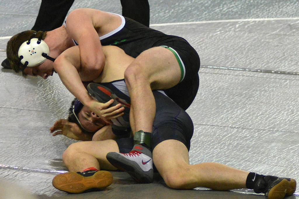A Kentwood wrestler competes for the take down during the WIAA state tournament. He won this round. Photo by Kayse Angel