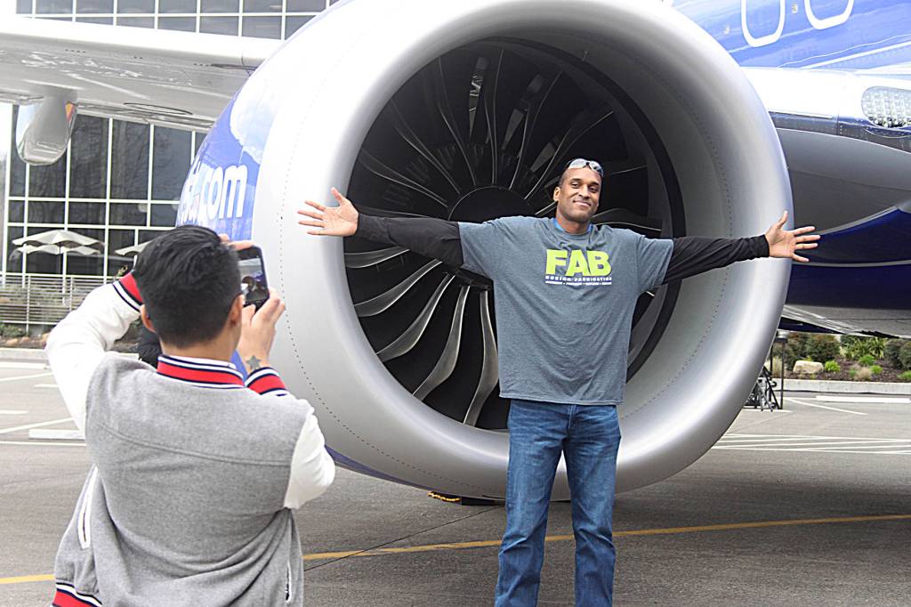 Ahron Goins, supply chain analyst at Boeing, poses in front of the 10,000th 737 airplane. Leah Abraham, Renton Reporter