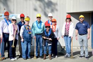 Councilmembers and other city staff members stand in front of the old beach house at Lake Wilderness Park. Photo by Kayse Angel