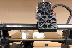 The 3D printer that is used in the engineering class at Kentwood prints out the hopefully last prototype for Sean Larue and his partners project that they made for their client who had a stroke. Photo by Kayse Angel