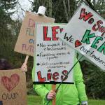 Local moms Dana Rosenberg, left, and Erin Leithead, right, wave their homemade signs at passing traffic on 256th Street in Kent outside of the KSD headquarters, drawing honks and cheers from drivers and passengers. Megan Saunders photo, for the Reporter