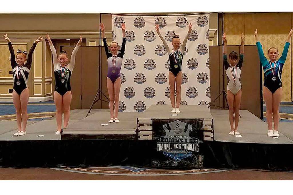Gymnasts pose in their respected placements. Submitted photo