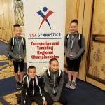 Gymnasts from Summit Gymnastics pose in front of a regionals sign to capture the memory of being there. Submitted photo