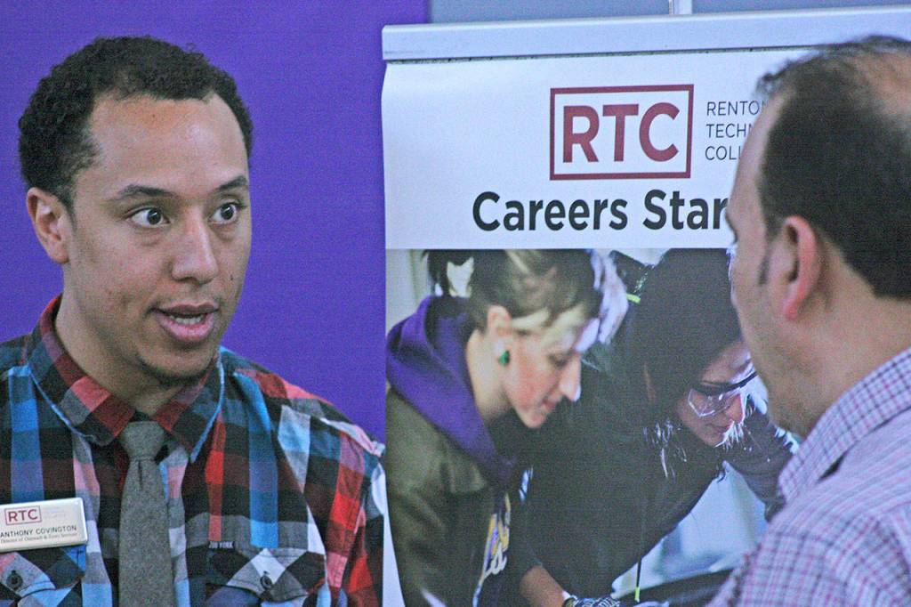 Anthony Covington, director of outreach and entry services at Renton Technical College, talks to an inquirer during a career fair at the Birch Creek Youth Center. MARK KLAAS, Kent Reporter