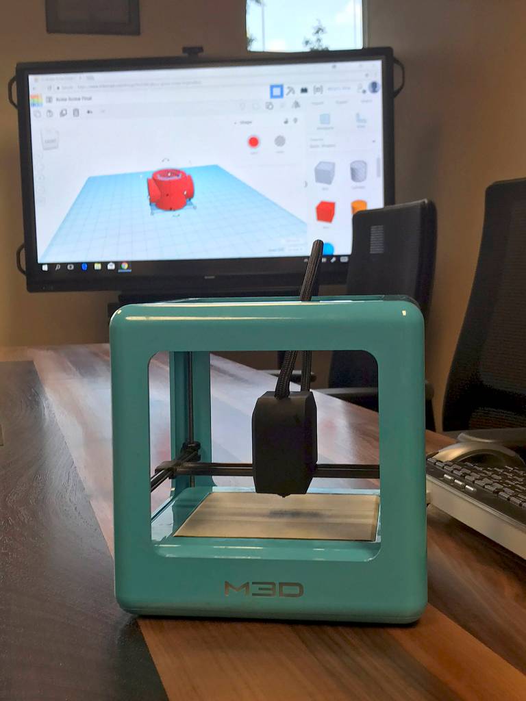 The 3D printer that Nathanael Junkin used to make the missing piece for the Covington Community Park Gate. Also displayed is the computer program he used. Photo by Kayse Angel