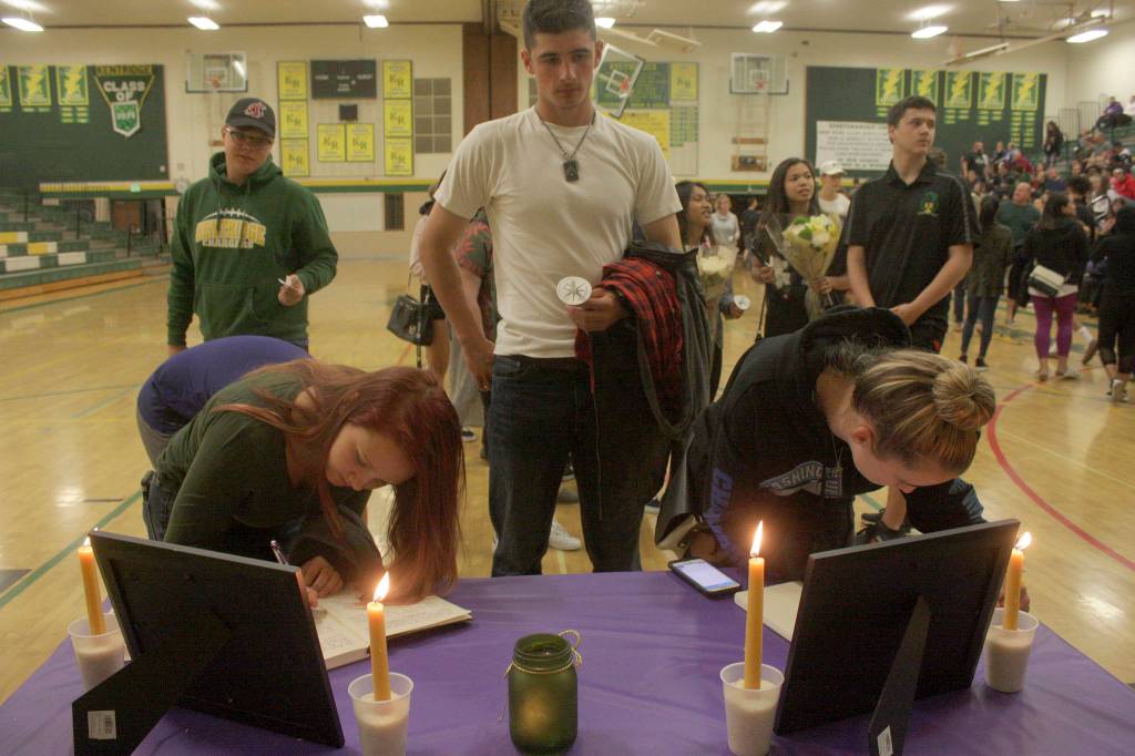Mark Klaas, Kent Reporter                                Students and supporters line up in the gym to sign memorial books to honor Eric Anderson, Kentridges athletic director who passed away Saturday.