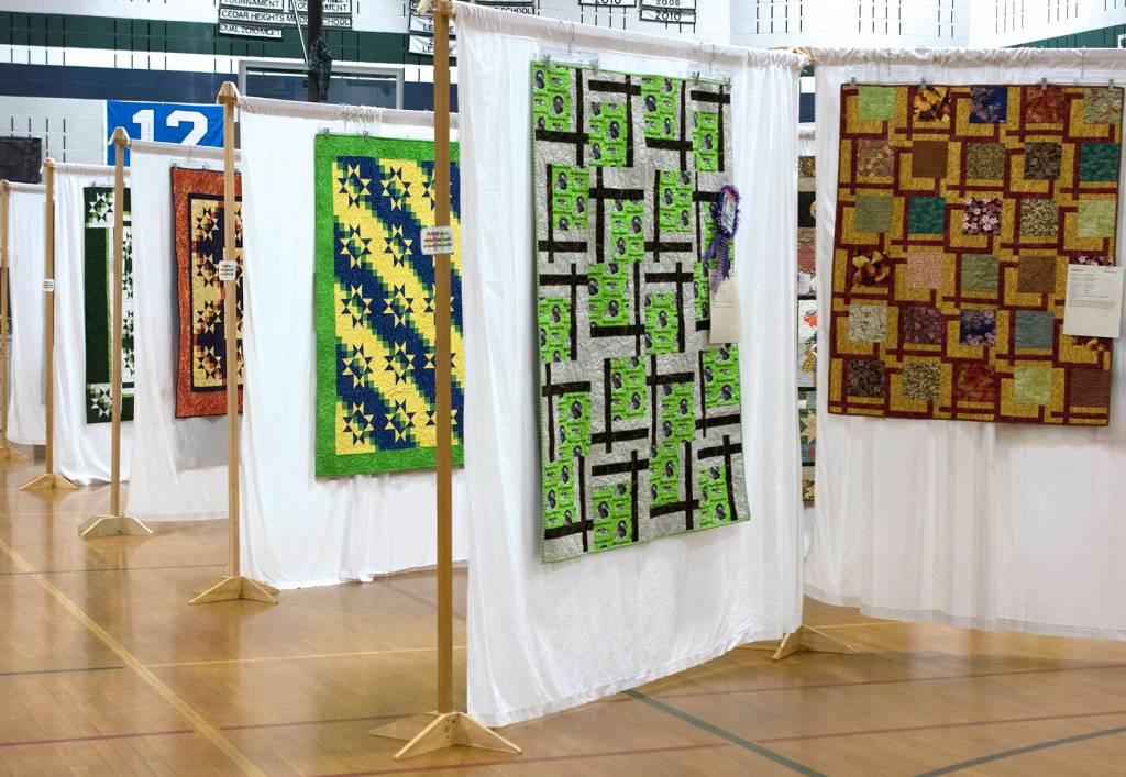 Photo by Kayse Angel                                Quilts that members of Covington Quilters Guild made hang on display.