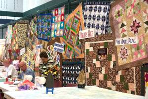 Photo by Kayse Angel                                Quilts the Covington Quilters Guild made for different organizations hang on display at the 2018 Quilt Show.