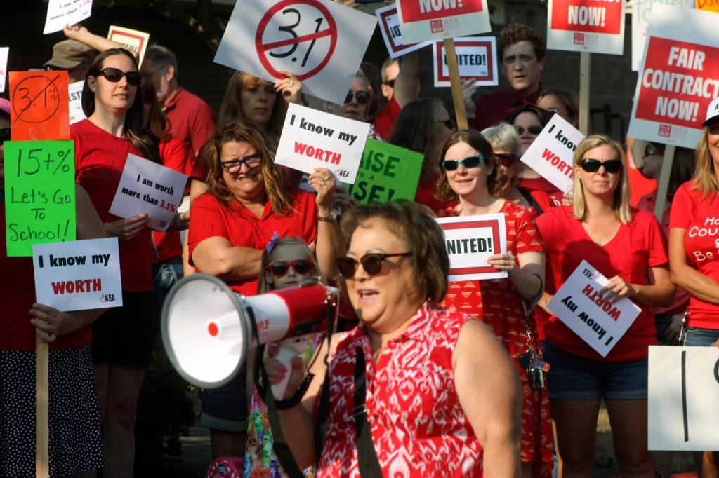 MARK KLAAS, Kent Reporter                                Teachers assemble in front of the Kent School District Office, listening to Lisa Brackin, an ELL teacher at Mill Creek Middle School, at the rally.