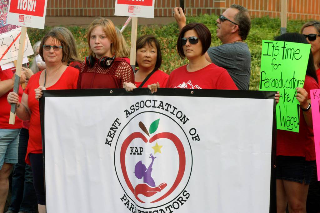 Kent Association of Paraeducators members rally outside the Kent School District Office on Aug. 22. MARK KLAAS, Kent Reporter