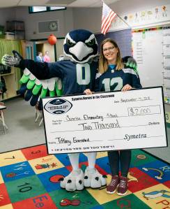 Sunrise Elementary School teacher Tiffany Evenstad and Blitz, the Seahawks mascot, at the award presentation. COURTESY PHOTO