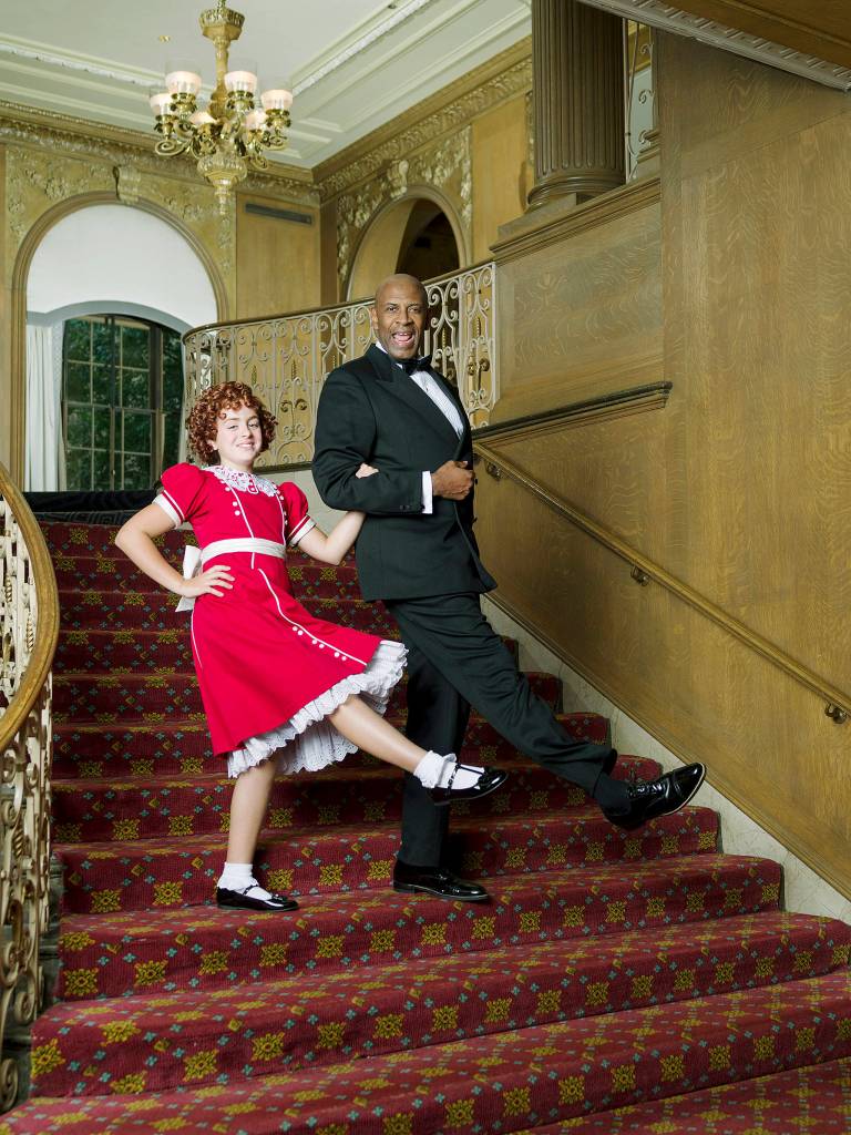 COURTESY PHOTO, Mark Kitaoka                                Faith Young as Annie, with Timothy McCuen Piggee as Daddy Warbucks in the 5th Avenue Theatres production of Annie.