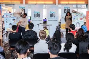 Russell Wilson and Ciara unveil the limited edition King County System Library cards that feature them and their dreams Friday at the Tukwila Library. The new library cards coincide with the newly launched DREAM BIG: Anything is Possible campaign. Courtesy photo by Why Not You Foundation