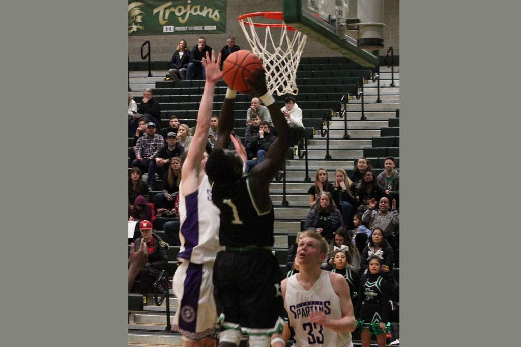 Junior guard Alphonse Oywak goes up for a basket during the second half of the loser out game Wednesday. Photo by Sarah Brenden