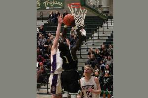 Junior guard Alphonse Oywak goes up for a basket during the second half of the loser out game Wednesday. Photo by Sarah Brenden