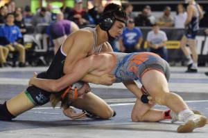 Kentwoods Alex Long, top, battles Auburn Mountainviews Brennen Hanson during their 152-pound semifinal at Mat Classic XXXI at the Tacoma Dome on Saturday. Long pulled out a 4-3 decision to reach the final. Rachel Ciampi, Kent Reporter