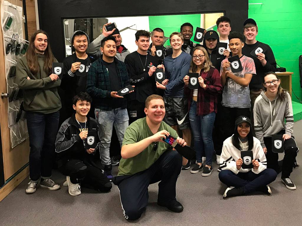 Photo by Kayse Angel                                 The Kentwood television broadcasting class hold up Cellslips, a device that automatically puts your phone into airplane mode. The class has been making videos to promote the slips for the Covington Police Department.