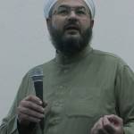 Shaykh Imad Al Busaad, imam of the Kent Islamic Center, speaks at a joint interfaith vigil and community gathering at the centers gym Friday night. Al Busaad urged people of all faiths to come together and strive for peace in an era of Islamophobia. MARK KLAAS, Kent Reporter