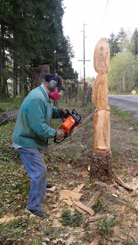 Ken Gruenes, Maple Valley resident, carves one of the large stumps in front of his property on SE 216th Street. Submitted photo from Jan Johnson-Schelvis