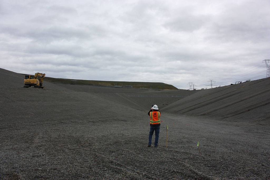 Scott Barden stands at the bottom of the massive pit of the landfills newly-built eighth section. Work on the new section has been underway for around two years. Aaron Kunkler/staff photo