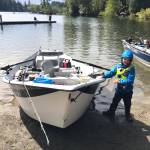 Brady Olson stands next to his fishing boat, excited as ever to go fishing on Lake Wilderness on April 27.
