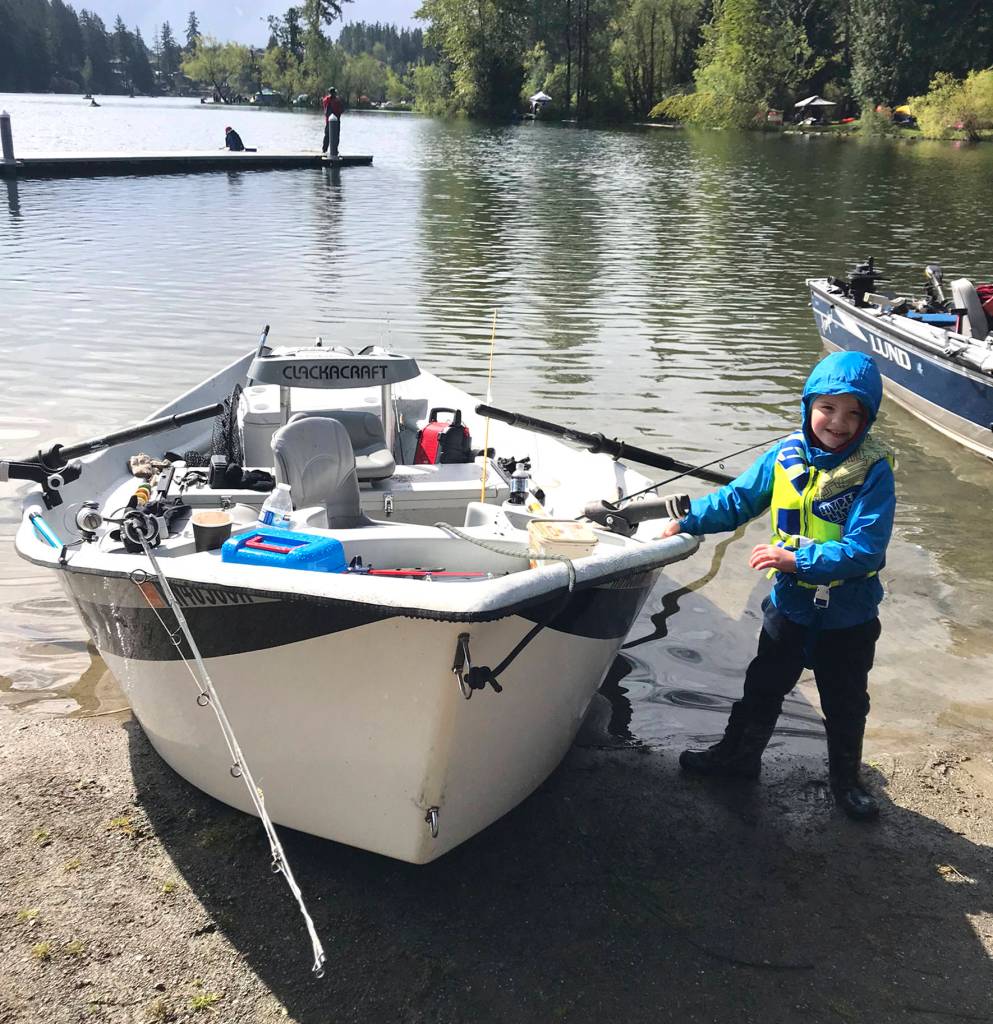 Brady Olson stands next to his fishing boat, excited as ever to go fishing on Lake Wilderness on April 27.