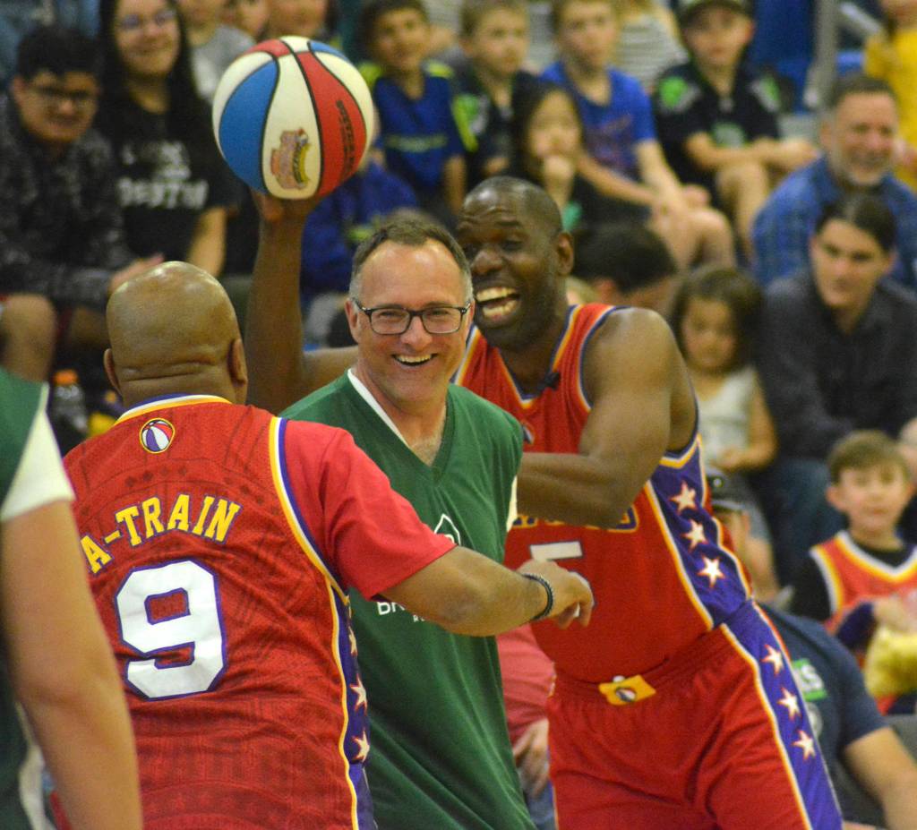Two Harlem Wizards play keep away with the ball from one of the Tahoma staff members during the fundraising event that took place on May 3 at Tahoma High School. Photo by Kayse Angel