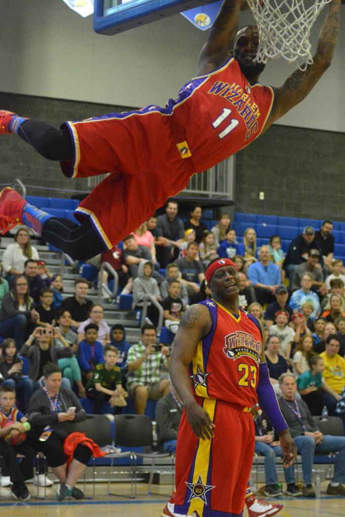 A Harlem Wizards player slam dunks a basketball during the fundraising event on May 3 at Tahoma High School. Photo by Kayse Angel