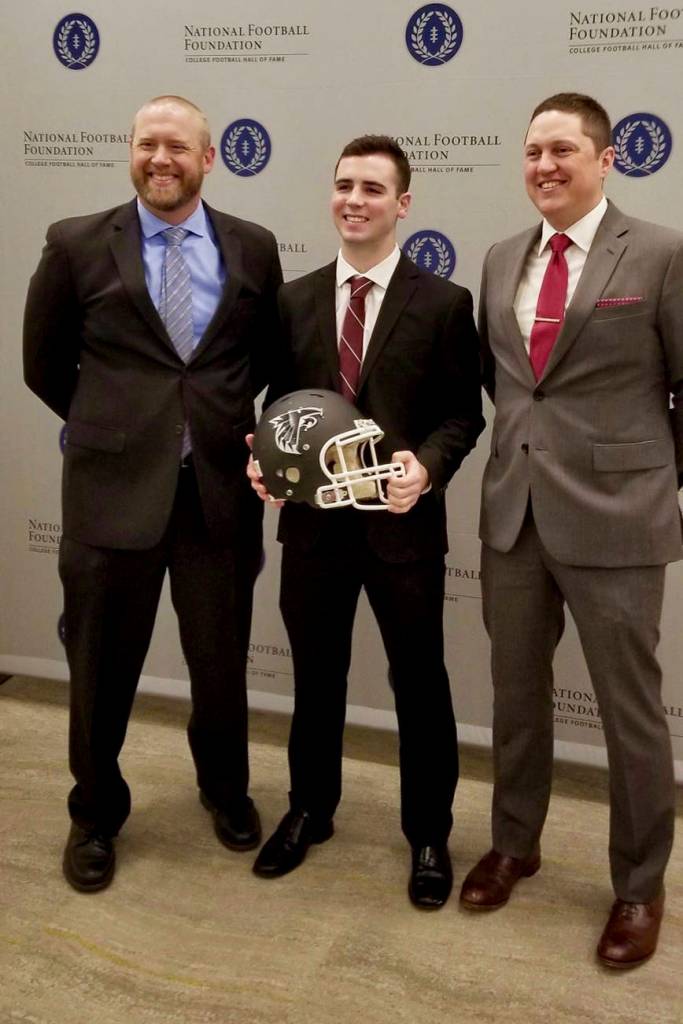 Hudson Potts receives his award with his coaches, Brett Thompson, left, and Kevin Hurt. COURTESY PHOTO