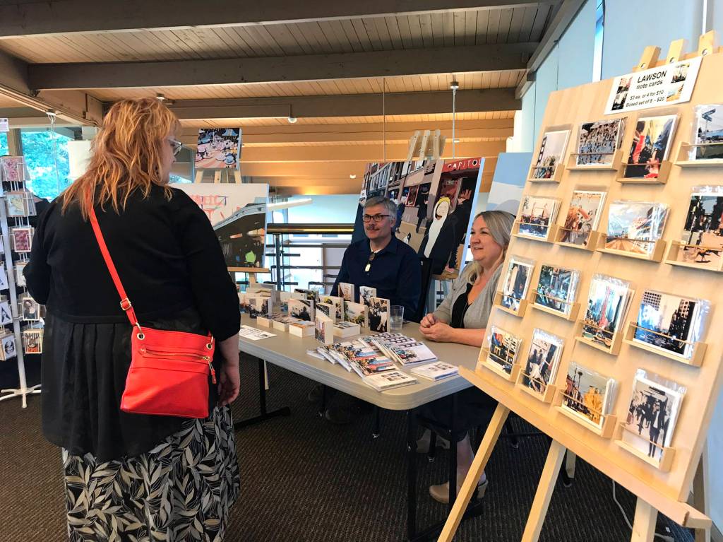 Photo by Kayse Angel                                 A community member checks out artist Beth Lawsons work during the Lake Wilderness Lodge Art Exhibition Grand Opening on May 8.
