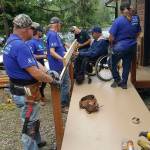 Photo courtesy of Building Beyond the Walls                                 Building Beyond the Walls volunteers building Terry Hildebrands ramp alongside his family.