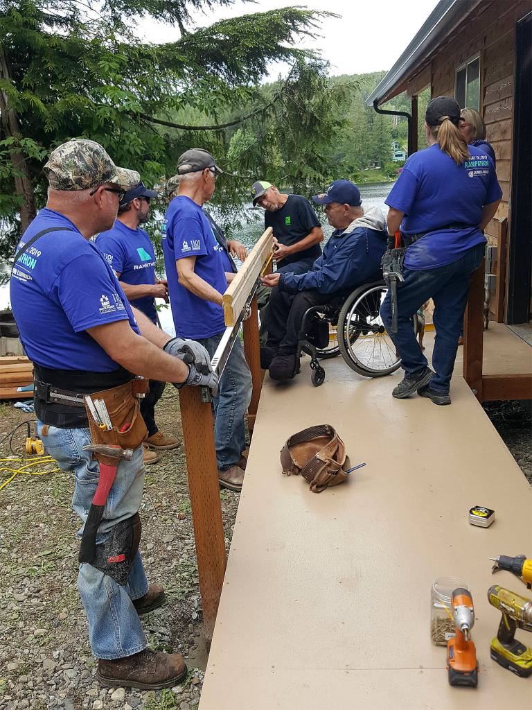 Photo courtesy of Building Beyond the Walls                                 Building Beyond the Walls volunteers building Terry Hildebrands ramp alongside his family.