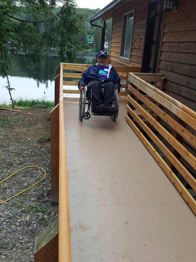 Terry Hildebrand testing out his new ramp by doing a wheelie in his wheelchair.                                Photo courtesy of Building Beyond the Walls