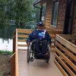 Terry Hildebrand testing out his new ramp by doing a wheelie in his wheelchair.                                Photo courtesy of Building Beyond the Walls