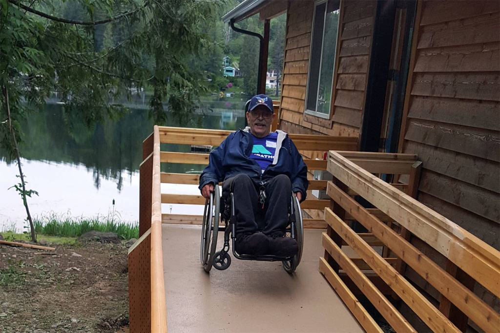 Terry Hildebrand testing out his new ramp by doing a wheelie in his wheelchair.                                Photo courtesy of Building Beyond the Walls