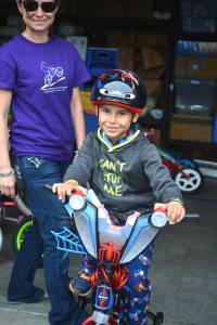 Photo by Kayse Angel                                 Brad Belchers grandson, Adrian Culberson, tests out one of the bikes donated to the Bicycle Rescue for Youth.