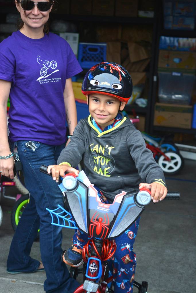 Photo by Kayse Angel                                 Brad Belchers grandson, Adrian Culberson, tests out one of the bikes donated to the Bicycle Rescue for Youth.