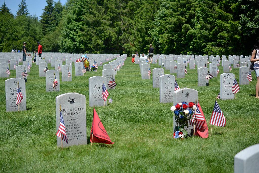 Photos by Kayse Angel                                 Grave stones with flags and flowers at the Tahoma National Cemetery on May 27.