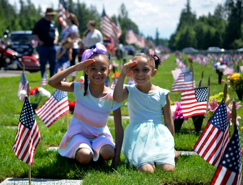 Photos by Kayse Angel                                 Jaya and Keira Stroud salute on Memorial Day at the Tahoma National Cemetery on May 27.