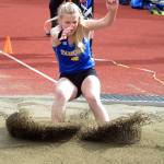Tahoma track student Katie Welsh leaps into the sand during the long jump. File photo by Kayse Angel