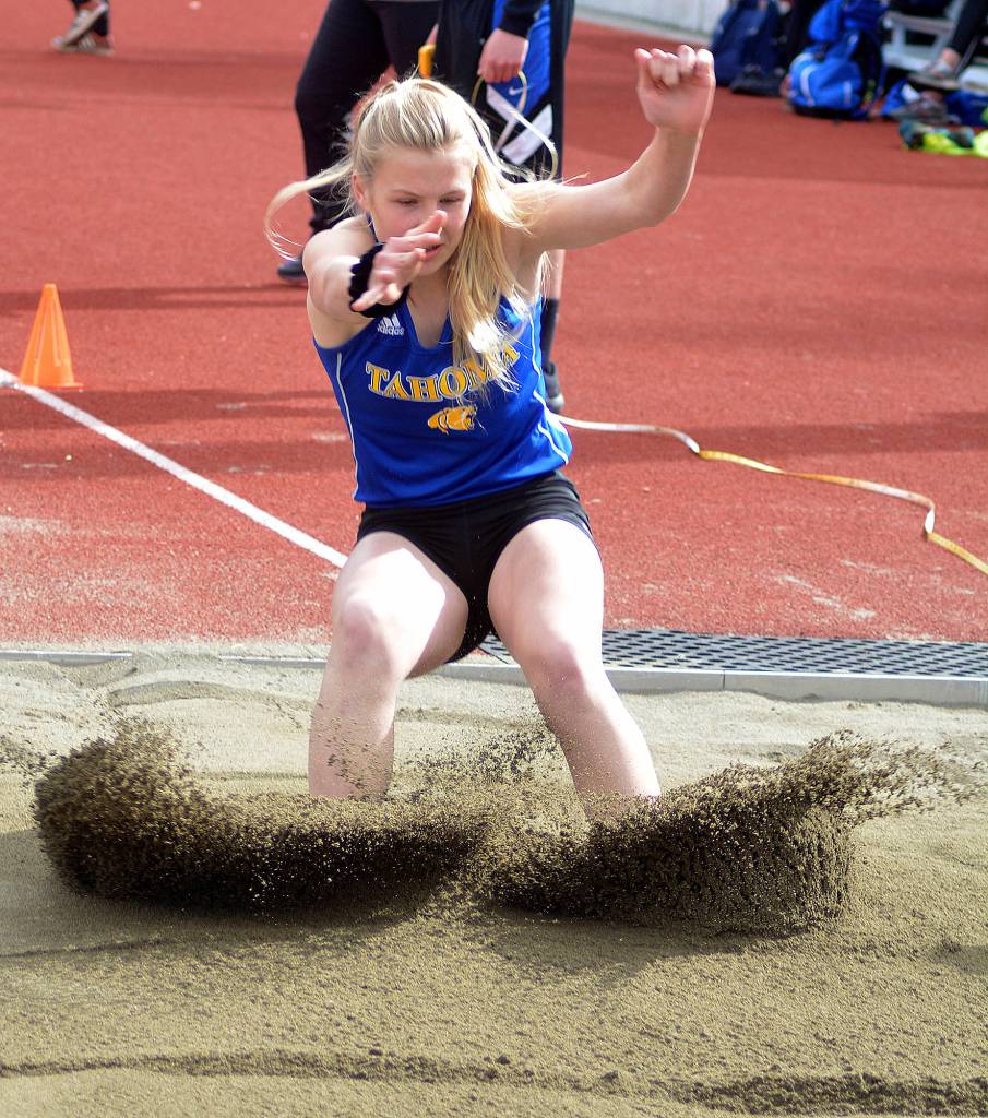 Tahoma track student Katie Welsh leaps into the sand during the long jump. File photo by Kayse Angel