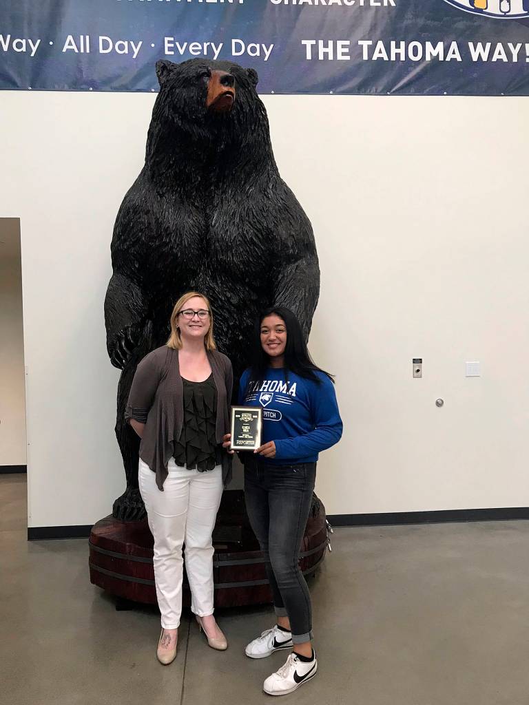 Photo by Kayse Angel                                 Kaiea Higa (right), a freshman fast pitch player for the Tahoma High School Bears, won the first ever Female Athlete of the Year award from the Covington-Maple Valley Reporter. She received a special plaque from the Reporters editor Danielle Chastaine (left).