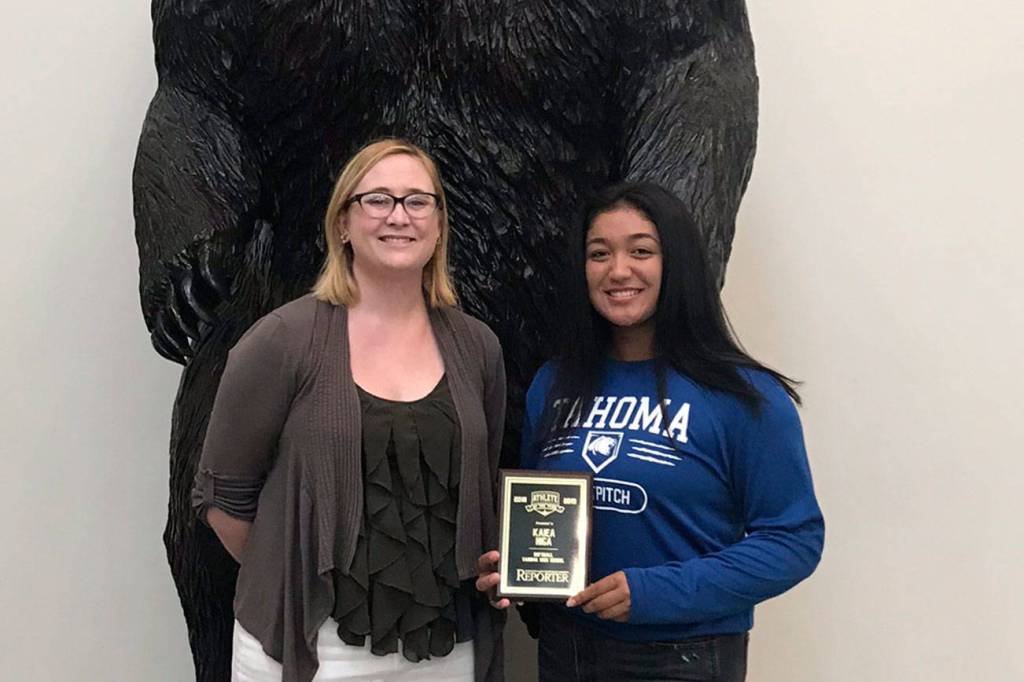 Photo by Kayse Angel                                 Kaiea Higa (right), a freshman fast pitch player for the Tahoma High School Bears, won the first ever Female Athlete of the Year award from the Covington-Maple Valley Reporter. She received a special plaque from the Reporters editor Danielle Chastaine (left).